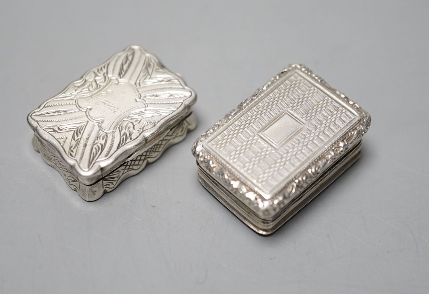 A George IV engine turned silver rectangular vinaigrette, Thomas & William Simpson, Birmingham, 1823, 30mm and a later silver vinaigrette by George Unite, Birmingham, 1866, engraved with the name 'Emmie', 29mm.
